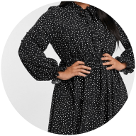 Woman wearing button down black and white spot dress