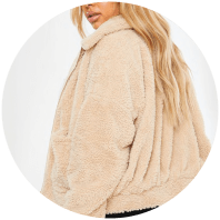 Model wears beige Short Bomber Jacket from In The Style Curve